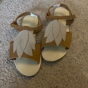 Brown sandals from Gymboree with cream colored soles. Velcro buckle at ankle.
